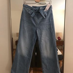 Wide leg, high rise jeans with denim belt.